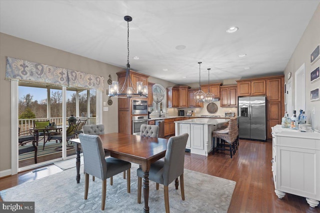 dining area featuring dark wood-style floors, a chandelier, and recessed lighting