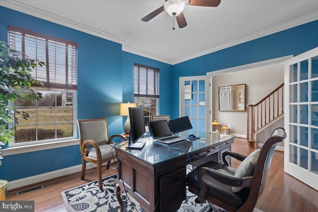 office area with ornamental molding, visible vents, and wood finished floors