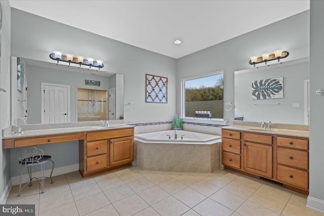 full bathroom featuring two vanities, a garden tub, a sink, and tile patterned floors