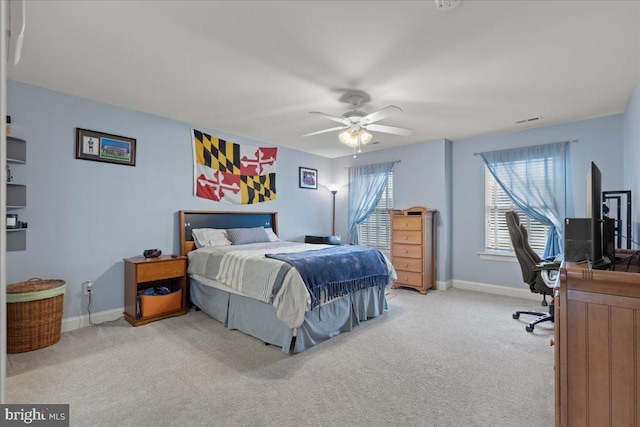 bedroom with ceiling fan, carpet flooring, visible vents, and baseboards