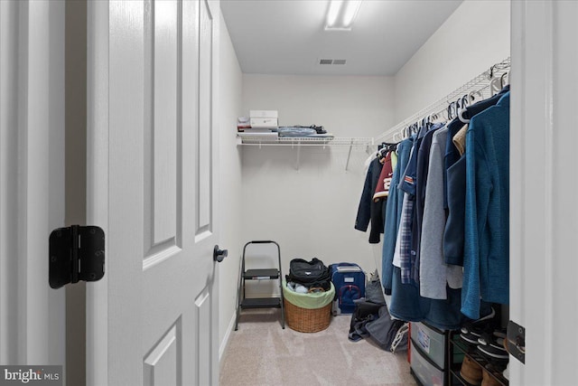 spacious closet with carpet floors and visible vents