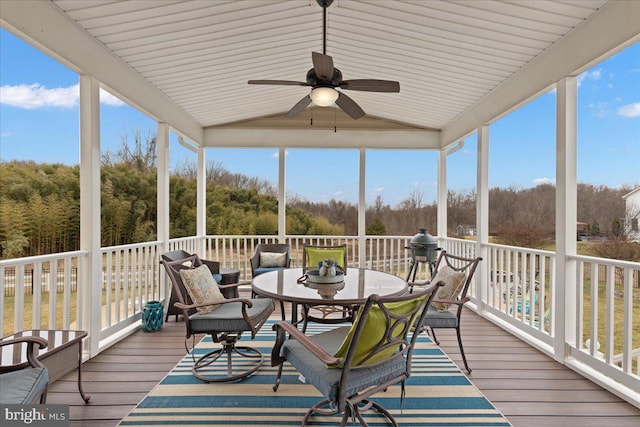 sunroom / solarium featuring a ceiling fan and vaulted ceiling