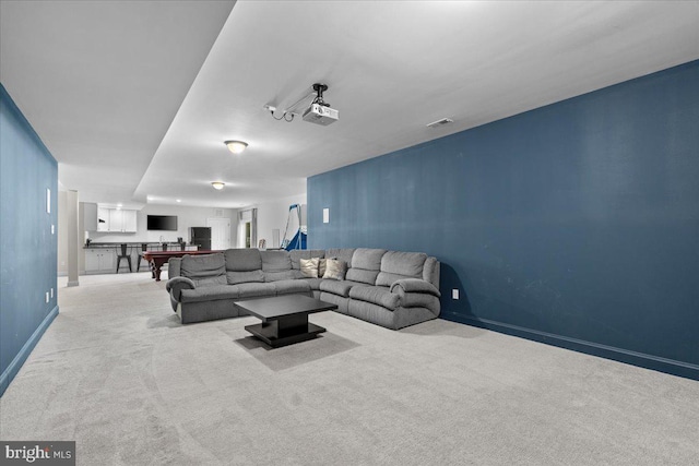 living area featuring carpet and baseboards