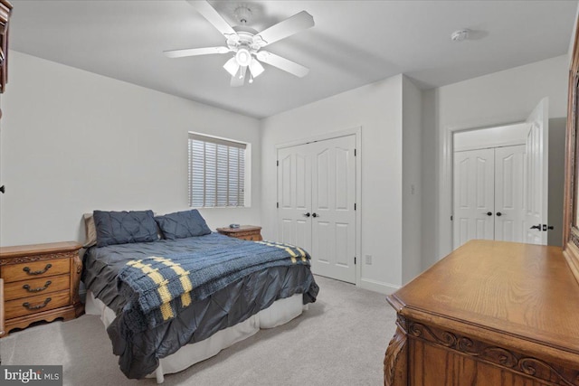 bedroom with light carpet, ceiling fan, and baseboards