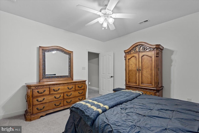 bedroom featuring visible vents, light carpet, and baseboards