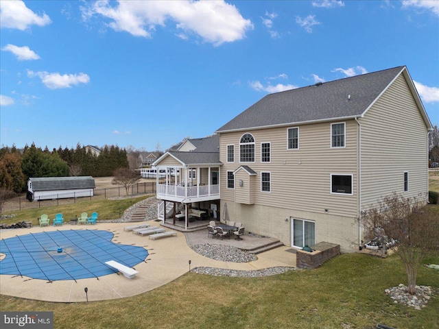 rear view of house featuring a patio area, fence, stairway, and a yard