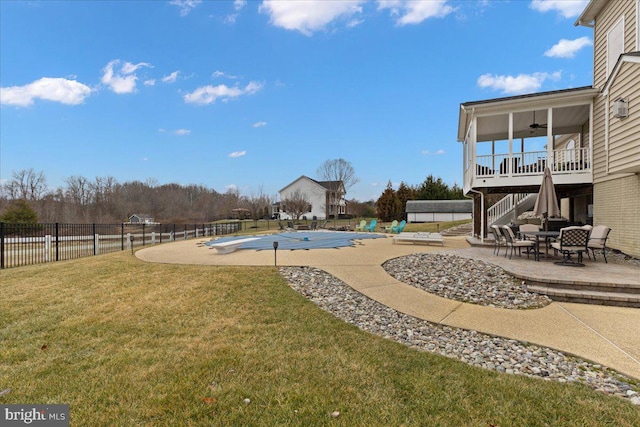 view of yard with a patio area, stairs, fence, and a ceiling fan