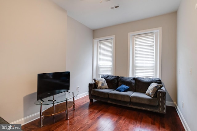 living room featuring dark hardwood / wood-style floors and a wealth of natural light