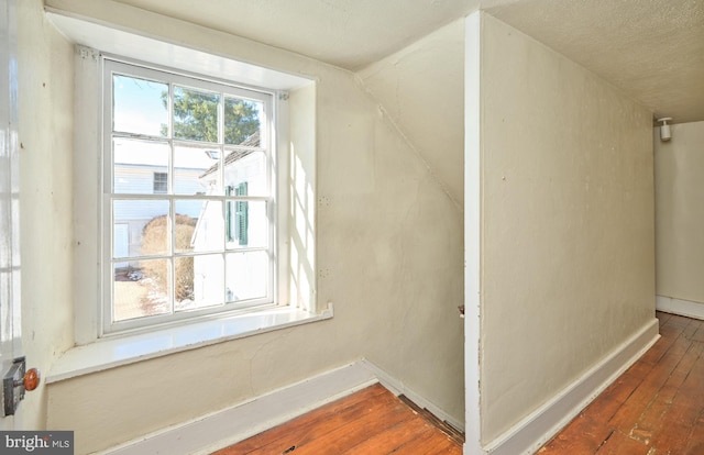 bonus room with dark wood-type flooring