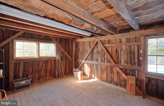 misc room with wooden walls and light hardwood / wood-style flooring