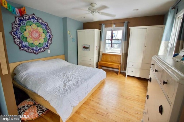 bedroom with ceiling fan and light hardwood / wood-style flooring