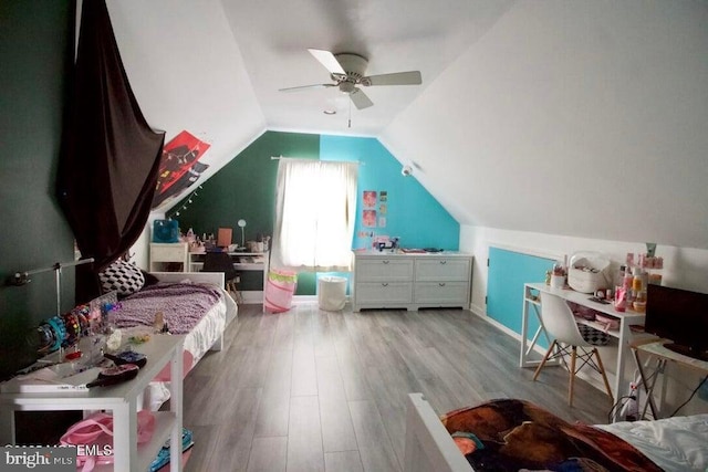 bedroom with ceiling fan, lofted ceiling, and light hardwood / wood-style flooring