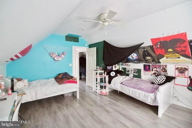 bedroom featuring lofted ceiling, light hardwood / wood-style flooring, and ceiling fan