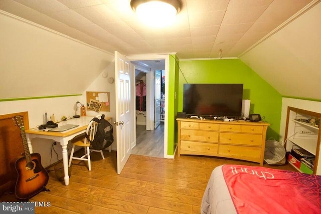 bedroom with lofted ceiling and hardwood / wood-style floors