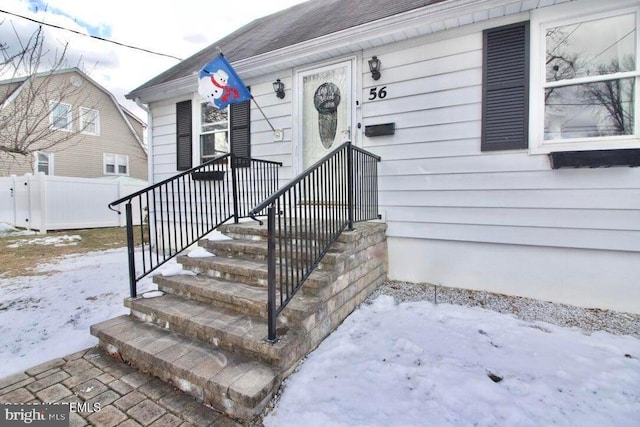 view of snow covered property entrance