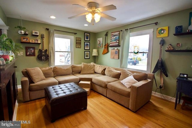 living room featuring ceiling fan and light wood-type flooring