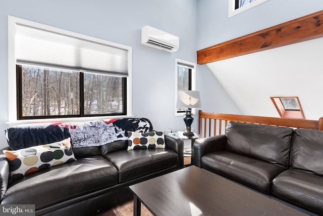 living room featuring vaulted ceiling with skylight and an AC wall unit