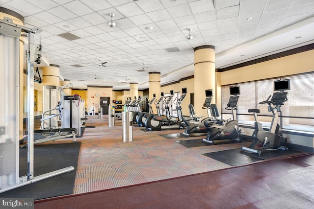 exercise room with crown molding and a drop ceiling