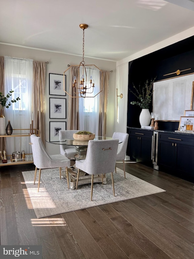 dining space with dark wood-type flooring and an inviting chandelier