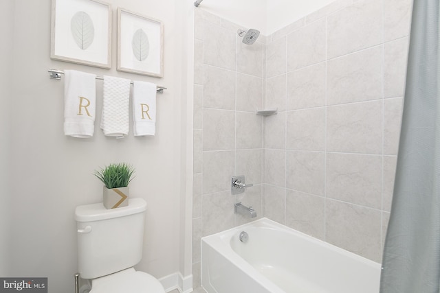 bathroom featuring shower / bath combo and toilet