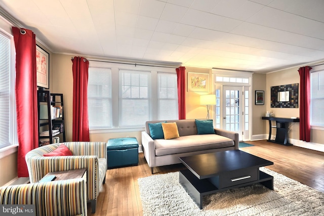 living room with ornamental molding and light hardwood / wood-style floors