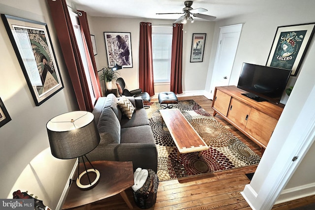 living room with dark hardwood / wood-style floors and ceiling fan