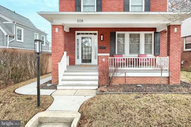 property entrance with covered porch