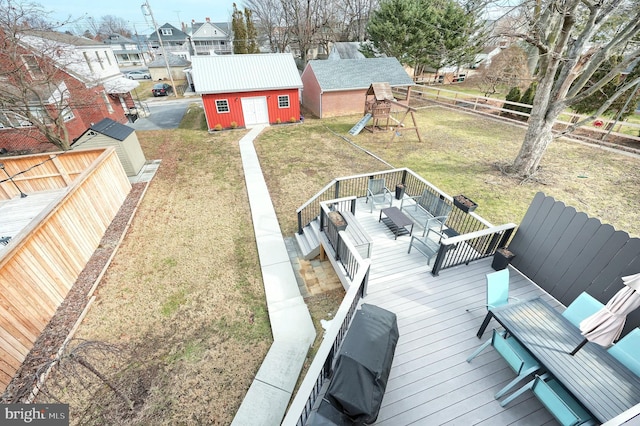 exterior space featuring a playground, a yard, and a storage unit