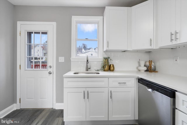 kitchen with sink, dishwasher, backsplash, white cabinets, and dark hardwood / wood-style flooring