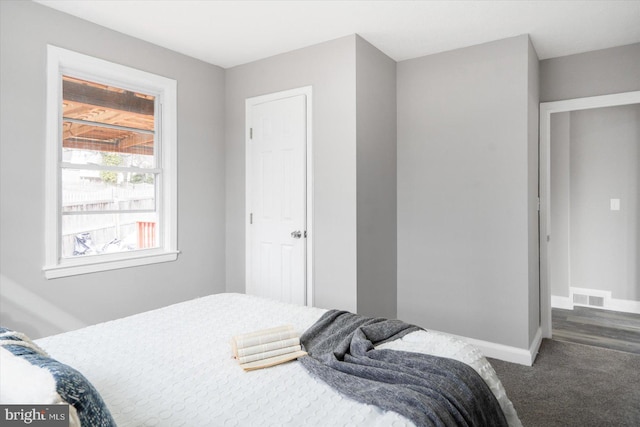 bedroom featuring dark carpet