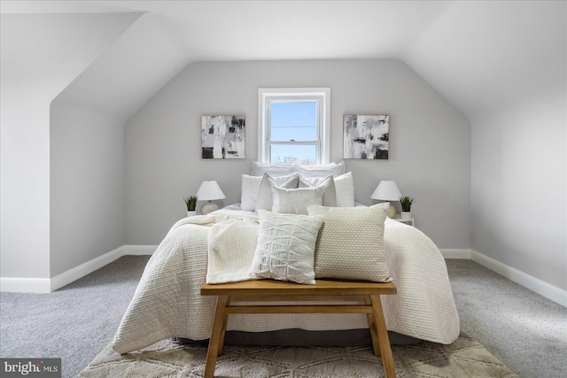 carpeted bedroom with vaulted ceiling