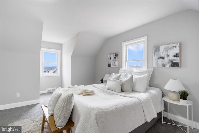 bedroom featuring lofted ceiling and carpet