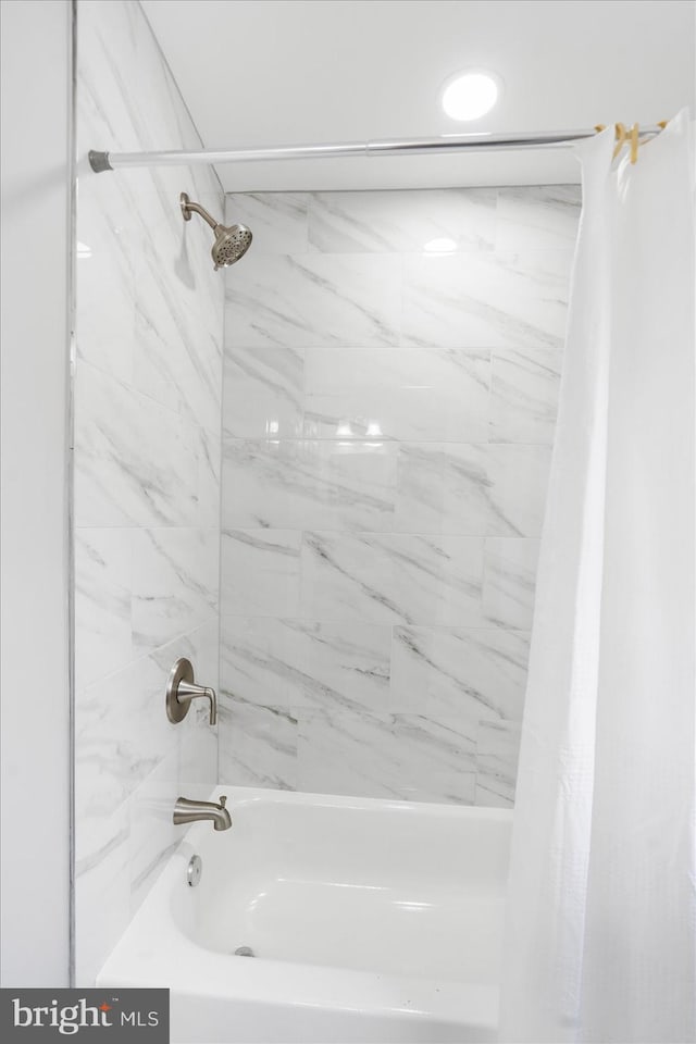 bathroom with shower / tub combo with curtain