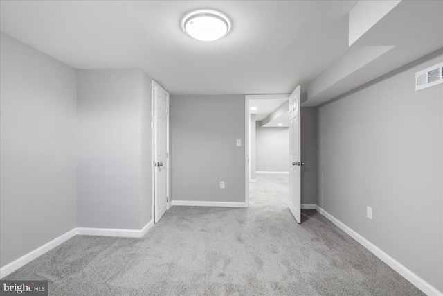 basement featuring light colored carpet