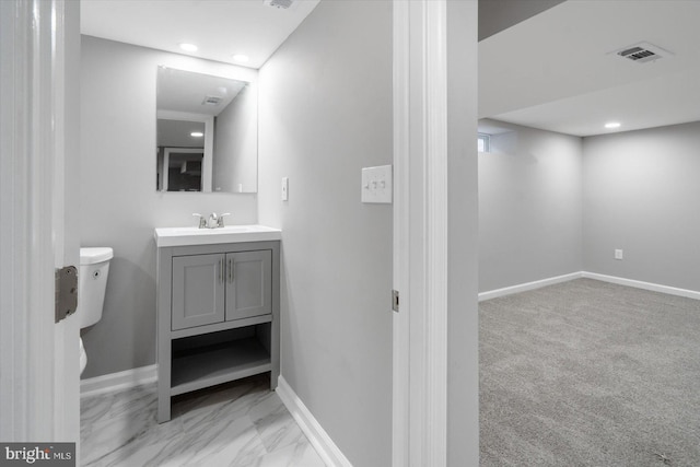 bathroom with vanity and toilet