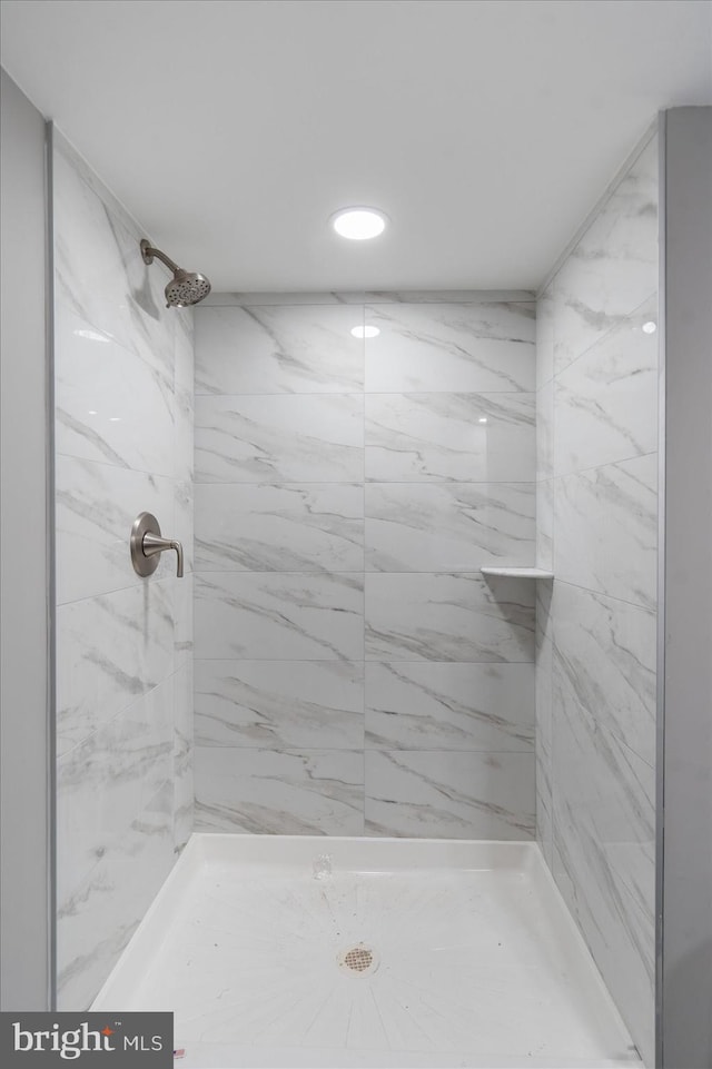 bathroom with a tile shower