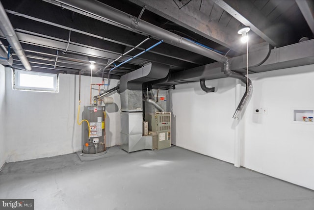 basement featuring gas water heater and heating unit