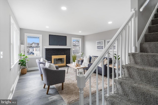 living room featuring wood-type flooring and a fireplace