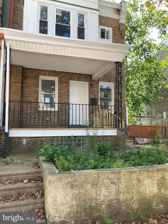 view of exterior entry featuring a porch