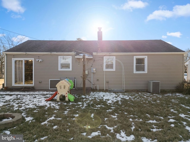 snow covered house featuring central air condition unit