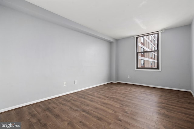 empty room with dark hardwood / wood-style floors