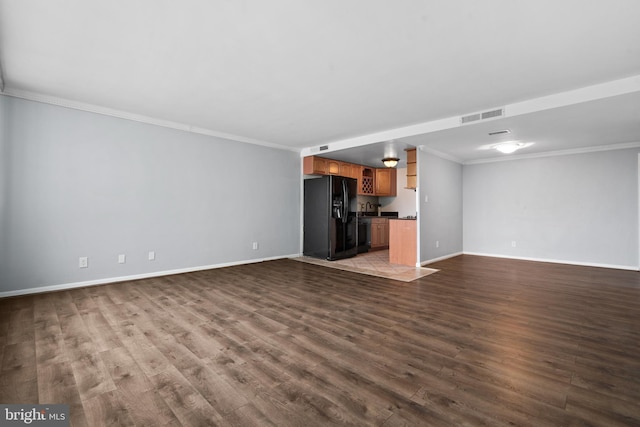 unfurnished living room featuring crown molding and hardwood / wood-style flooring