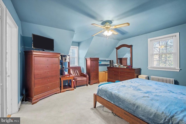 bedroom featuring lofted ceiling, radiator, light carpet, and ceiling fan