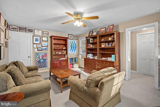 carpeted living room with ceiling fan