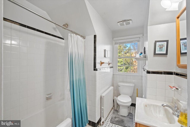 full bathroom with toilet, tile walls, vanity, radiator, and shower / bath combination with curtain