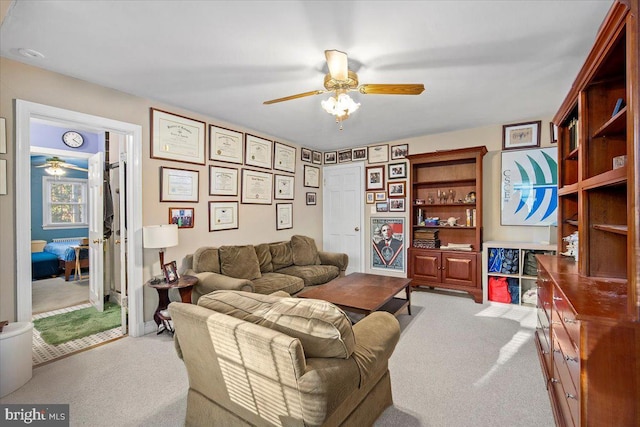 living room with light carpet and ceiling fan