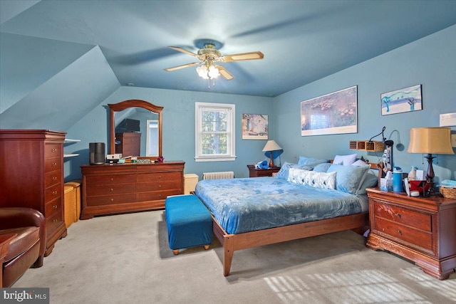 carpeted bedroom with ceiling fan, lofted ceiling, and radiator