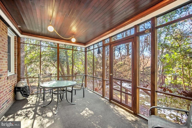 unfurnished sunroom featuring wooden ceiling