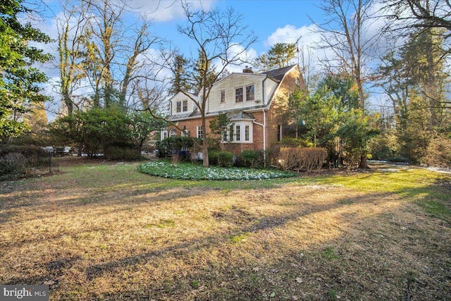 view of home's exterior with a lawn