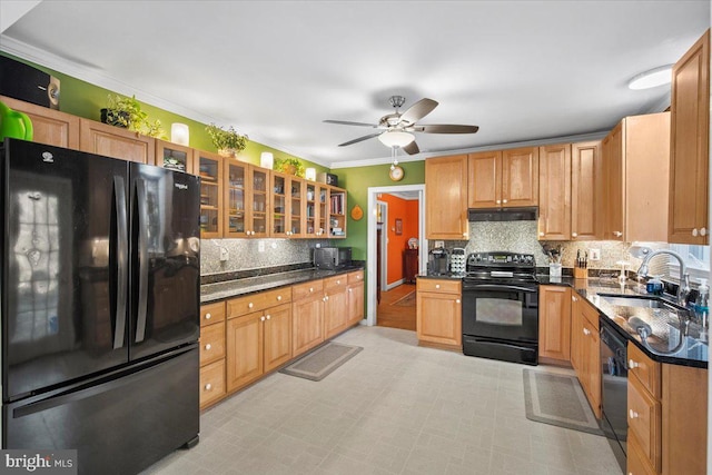 kitchen with sink, crown molding, black appliances, dark stone countertops, and backsplash